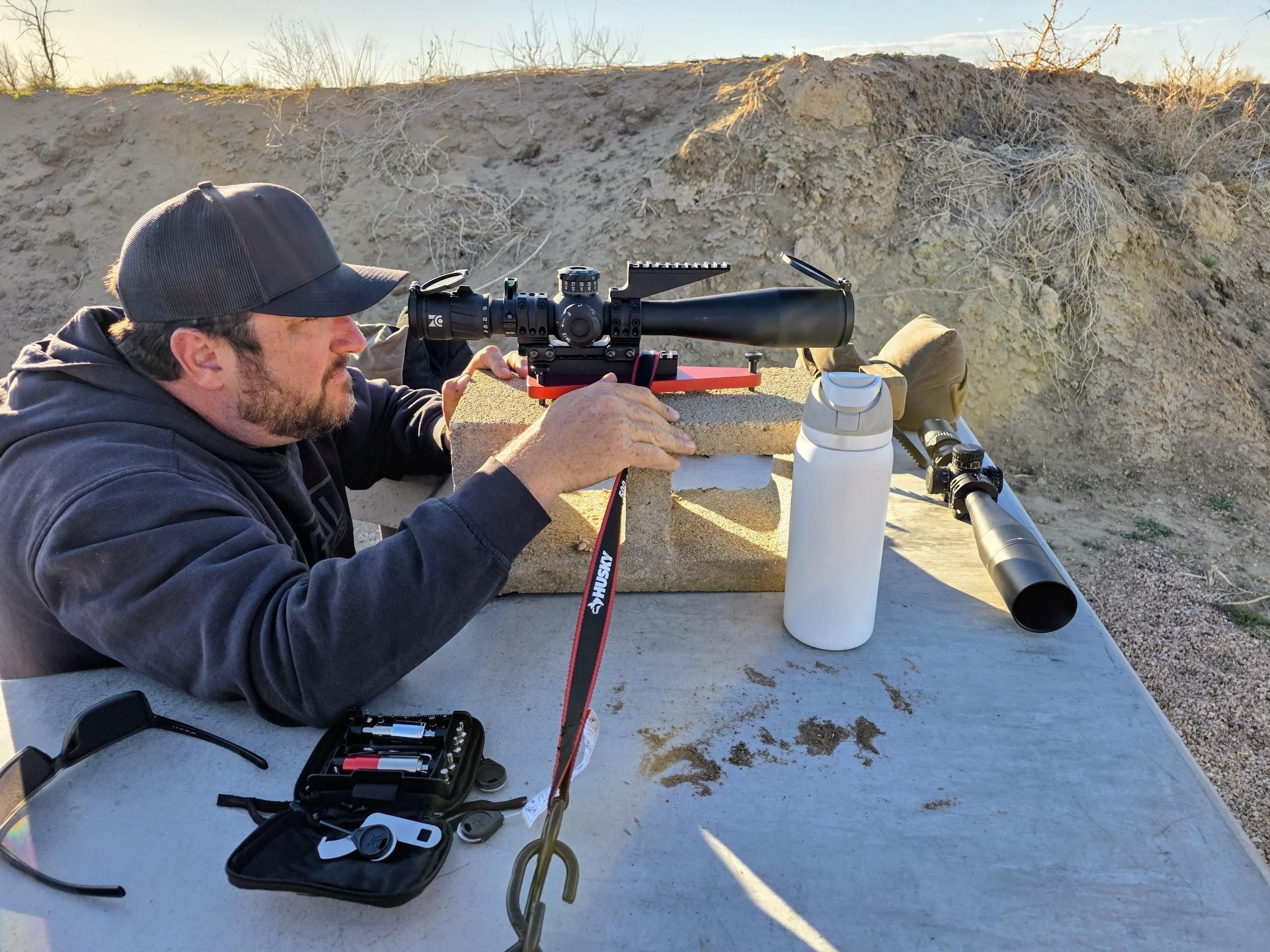 Scope mounted on Badger Ordnance Dead Level on a cinder block and table for a tracking test